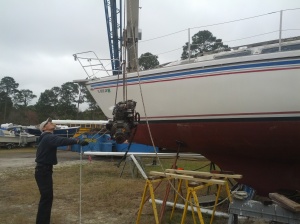 yanmar 2gm20f being lifted out of a catalina 30 by crane
